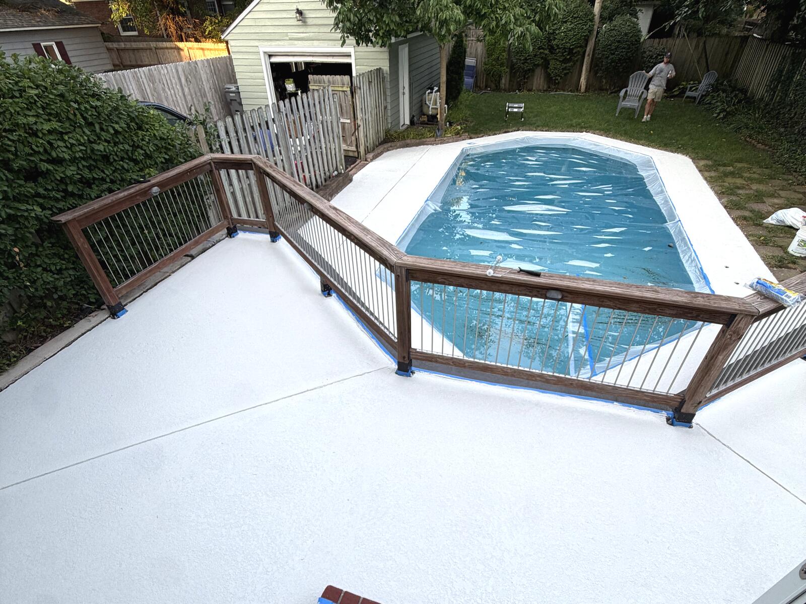 Finished pool deck and patio seen from the upper deck