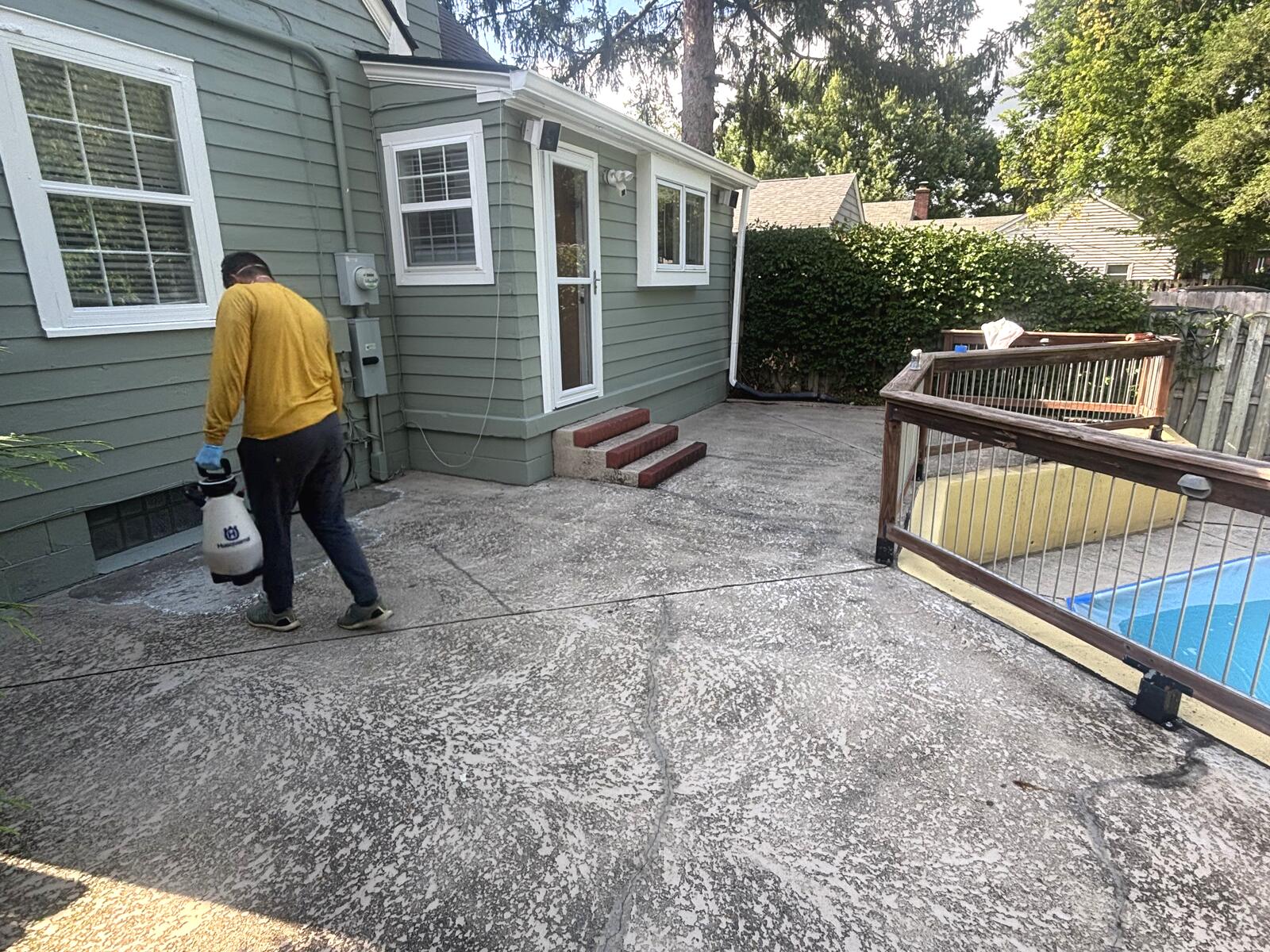 Cleaning and etching the concrete patio before coating